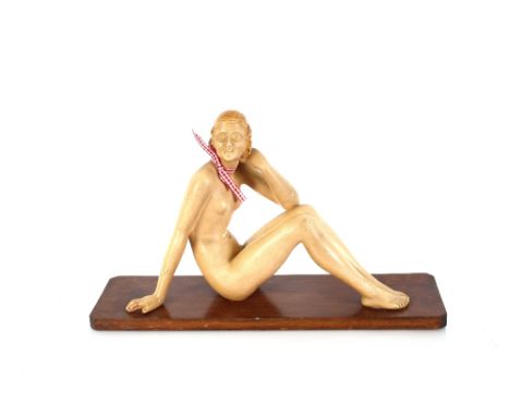 An Art Deco plaster figure in the form of nude seated female, 34cm high 