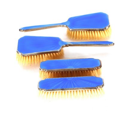 Four silver and blue enamel decorated dressing table hand brushes