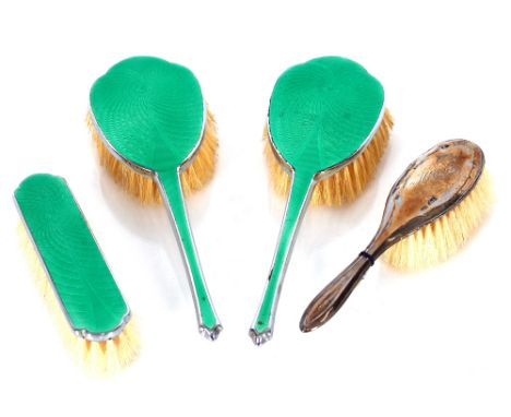 A silver backed dressing table brush and three English made chrome and green enamel decorated brushes