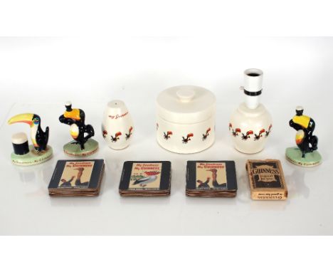 A Carlton ware Guinness Toucan advertising pot and cover; a similar table lamp; and salt shaker; a pack of Guinness advertisi