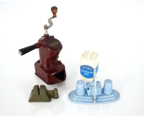 A collection of mostly Bakelite homewares including egg slicers, juicers, cruets, knife sharpener, coffee grinder etc.
