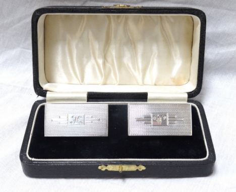 PAIR OF GEORGE V ART DECO SILVER NAPKIN RINGS
of oblong design with engine turned decoration, Birmingham 1934, with fitted ca