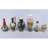A Doulton Lambeth faience vase with floral decoration, 9 1/2" high, three similar vases, a similar