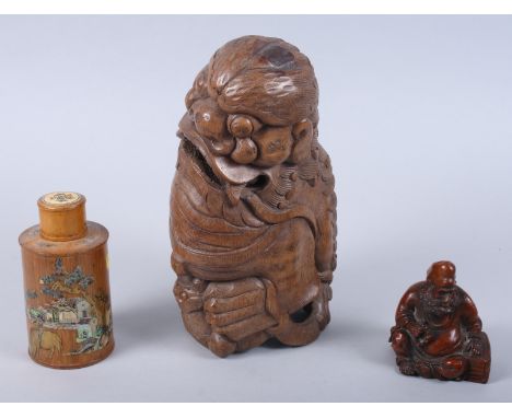 A Chinese carved bamboo figure of a Kylin, 10 1/2" high, a carved bamboo figure of a seated deity, 4" high, and an inlaid and