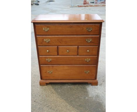 A cherrywood chest of five graduated drawers, on bracket feet, 40" wide and a companion chest of nine drawers