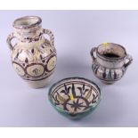 A North African slip decorated two-handled jar, 12" high, (surface cracking), a similar jar (