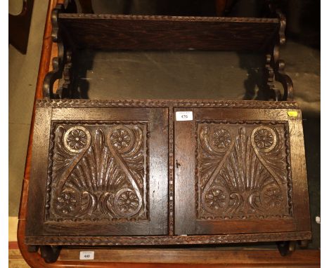 A mid Victorian carved oak wall cupboard enclosed two shell and scroll panelled doors with shelf over, 25" wide x 30" high