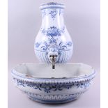 A Continental delftware water fountain and matching bowl with blue and white scroll and mask