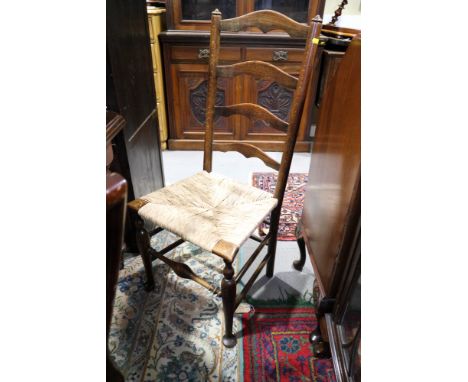 Two 19th century oak and ash ladder back chairs with rush envelope seats, on turned and stretchered supports, and a Lloyd Loo