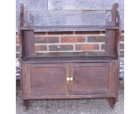 A late Victorian oak wall cupboard with shelf over two doors, 24" wide