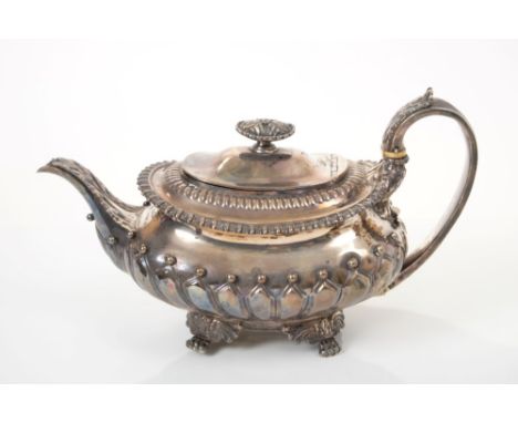 Early George IV silver teapot of compressed baluster form, with fluted and ball decoration, gadrooned borders and leaf-mounte