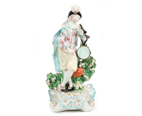 Late 18th century Derby figure of a musician with pipe and tambourine, with flower bocage, on rococo scroll base, 26cm