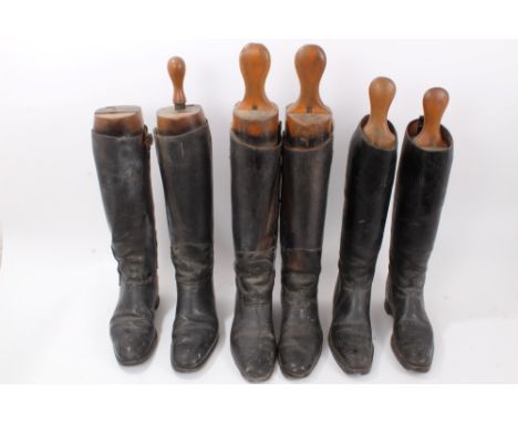 Three pairs of vintage black leather hunting boots, each with a set of wooden trees, one pair named to E. Rube, 1st Royal Dra