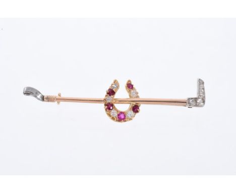 Edwardian gold ruby and diamond brooch in the form of a horseshoe and riding crop. 55mm