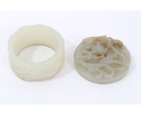 Chinese carved celadon jade hardstone disc carved to the upper face in high relief with prowling quillin and low relief repea