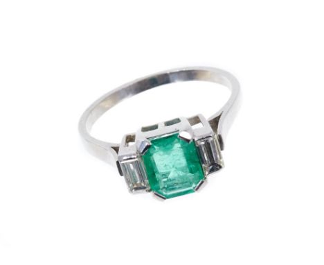 Art Deco-style emerald and diamond ring with an octagonal step cut emerald weighing approximately 1.04cts flanked by two bagu