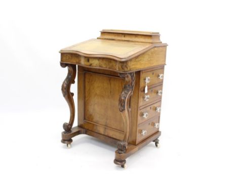 Victorian walnut serpentine fronted davenport desk with raised rear stationery compartment and leather inset slope enclosing 