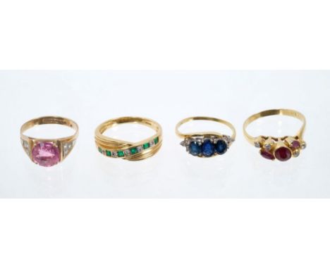 Four gold and gem set rings to include a ruby and diamond ring, blue sapphire three stone ring with diamonds to the shoulders