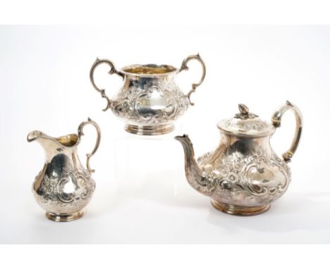 Victorian silver three piece tea set - comprising a teapot of baluster form, with embossed floral decoration, two vacant cart