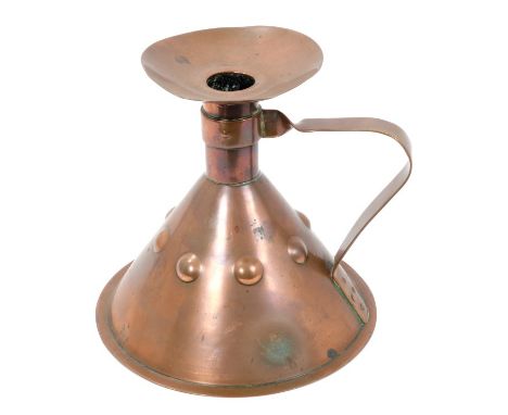 Edwardian Liberty &amp; Co Arts &amp; Crafts copper chamber candlestick of inverted funnel form with embossed roundels and lo