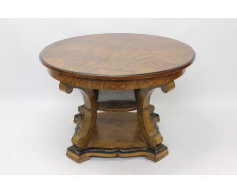 19th century Continental walnut centre table, circular figured top raised on concave supports united by circular shelf, on pl