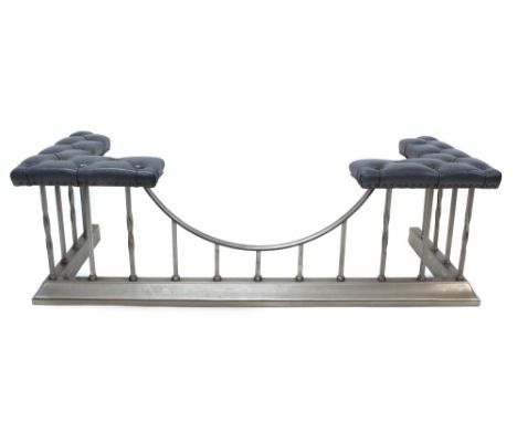 Modern button leather upholstered polished steel club fender with twisted bar supports to splayed kerb, 139cm long CONDITION 