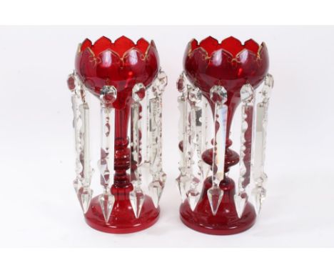Pair Mid-19th Century ruby glass lustres with castellated tops, gilt line decoration with prismatic glass drops, 32cm