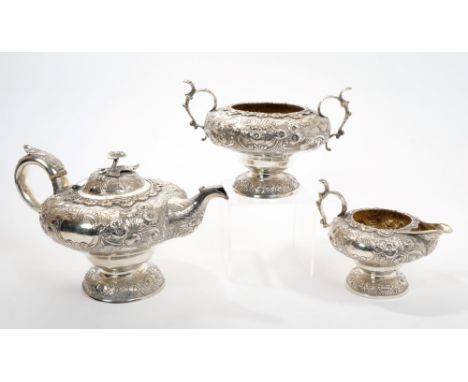 George III silver three piece tea set - comprising teapot of inverted baluster form, with embossed scroll and floral decorati