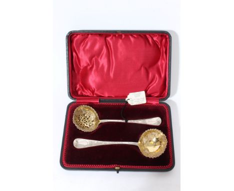 Matching pair of Victorian Provincial silver sifter spoon and ladle with grape and vine silver gilt bowls and engraved stems 