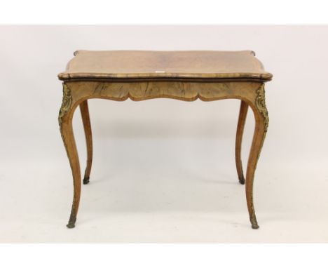 Good Victorian figured walnut, kingwood crossbanded and gilt metal mounted card table of serpentine outline, the fold-over to