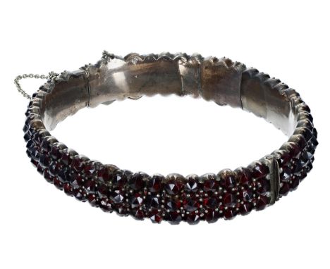 Garnet set gilt bangle with safety chain, 27.4gm;&nbsp;with a 9ct garnet pendant on a slender chain, 2.4gm 