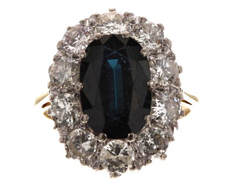 Large 18ct oval sapphire and diamond cluster ring, the sapphire 3.50ct approx, in a surround of ten round brilliant-cut diamo