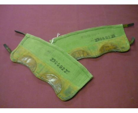 Pair of green canvas and leather Army Putees, stamped NEEED 1951 with broad arrow and numbered 23060225 (2) 