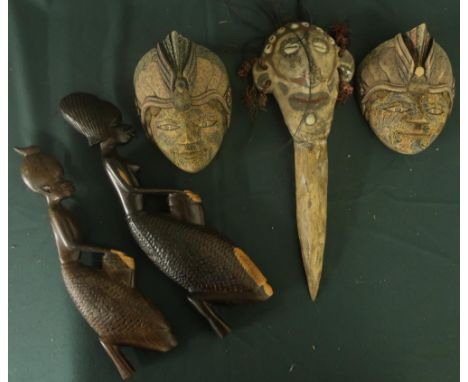 Tribal ceremonial bone dagger with moulded clay figure of a head, inset with shells and hair (overall length 30cm), two carve