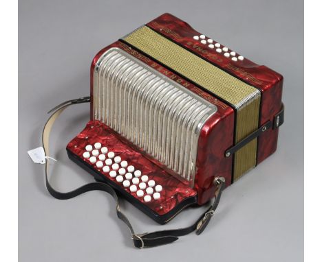 A Hohner “Corona II” piano accordion in a red polished case. 