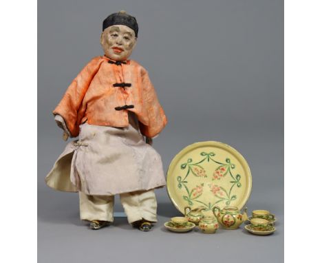 A vintage painted composition Chinese male doll, 25cm high, dressed; &amp; a floral painted wooden ten-piece part miniature t