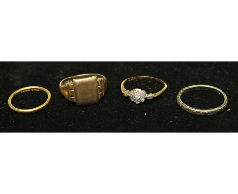 A 22ct gold wedding band, 2.4g; an 18ct gold ring, set with diamond chips, 1.9g; a 9ct gold signet ring, 4.9g; a silver etern