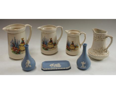 A pair of Wedgwood Jasperware bottle vases, a similar trinket tray; a set of three graduated crinoline lady jugs; a 19th cent
