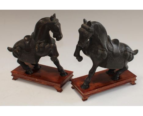 Chinese School - a pair of dark patinated bronze equestrian library desk models, after the Tang, 24cm high on stands (2)