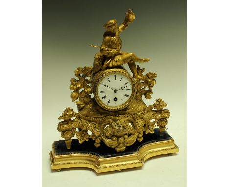 A 19th century French gilt metal mantel clock, white enamel dial, with Roman numerals, single winding hole, striking on a bel