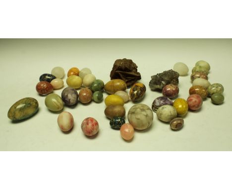 A polished hardstone egg, other similar polished specimen and hardstone eggs, an amethyst section; etc
