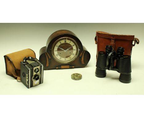 A pair of Pegasus field binoculars, 10 x 50, field 5.5, serial number 81349, leather case; an oak case mantel clock, twin win