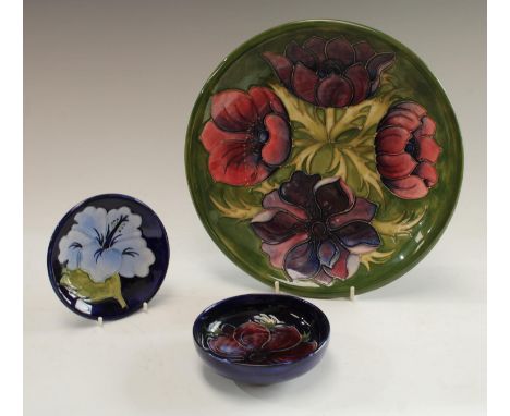 A Moorcroft Anemone pattern plate, 26cm diameter; an Anemone pattern circular dish, 11.5cm; an Hibiscus pattern trinket dish,