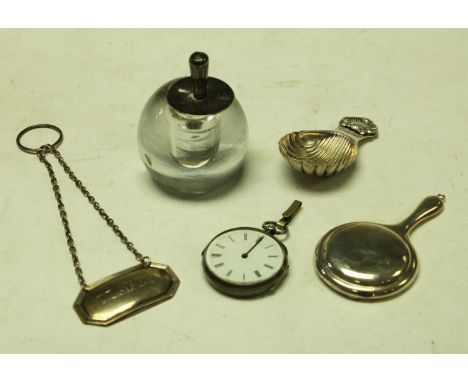 A silver caddy spoon, Sheffield 1977; a silver compact as a hand mirror, Birmingham 1924; a silver decanter label, London; a 