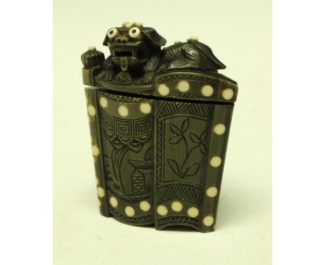 An unusual Chinese horn snuff box, the hinged cover carved with a Dog of Fo, the front with stylised flower heads within geom