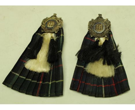 A Scottish Kings Own Borders enamel badge on miniature kilt and sporran; another similar (2)