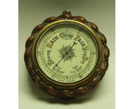 An Edwardian oak framed aneroid barometer
