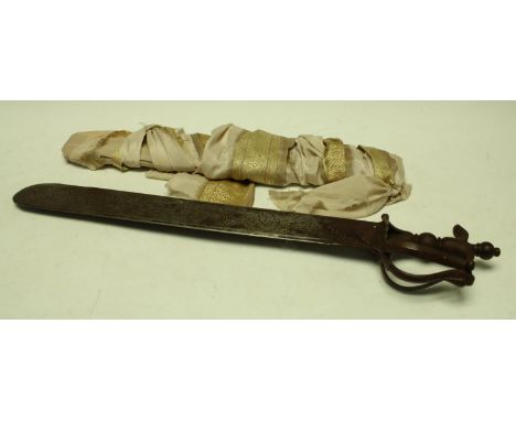 An Indian temple sword, the 47cm khanda type blade chased with a lion and other animals hunting, the steel hilt with scrollin