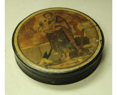 A 19th century papier mache circular snuff box, the push on cover applied with a biblical figure, St Joseph, 9cm diameter