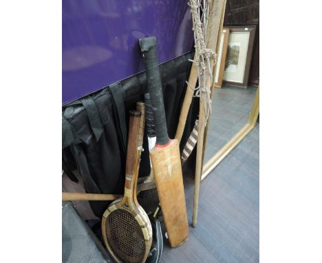 A selection of vintage sporting equipment including Lacrosse stick